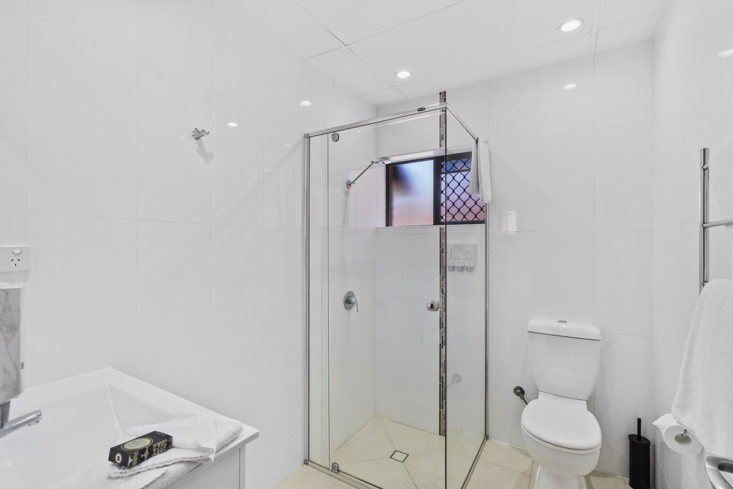 An ensuite bathroom with a walk-in glass shower and bath