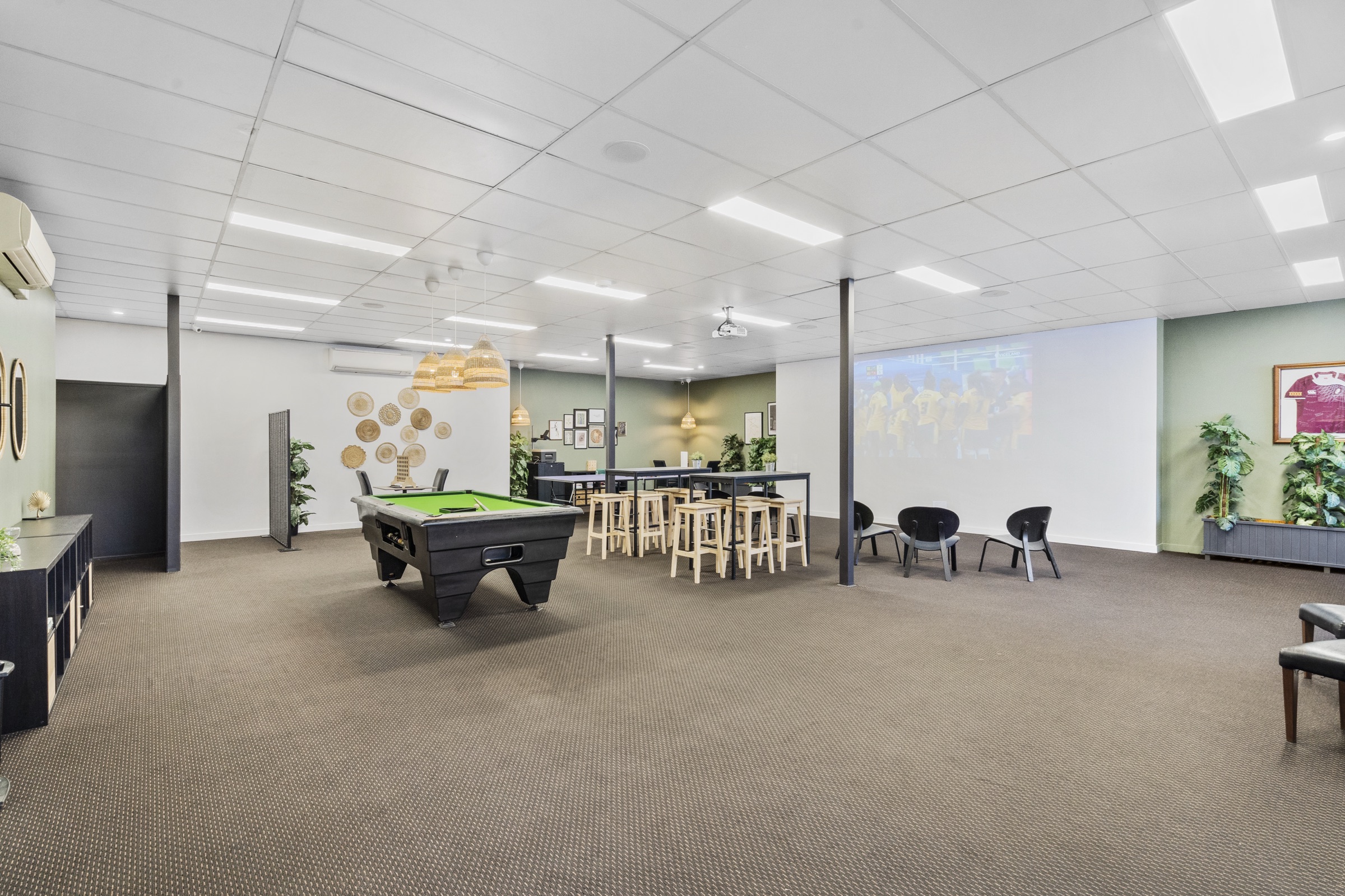 The games room with a billiard table and lounge seating